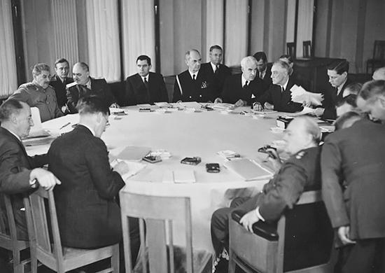 A group of people sitting around a table Description automatically generated