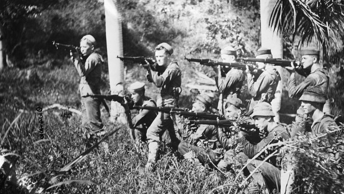 A group of soldiers holding rifles Description automatically generated