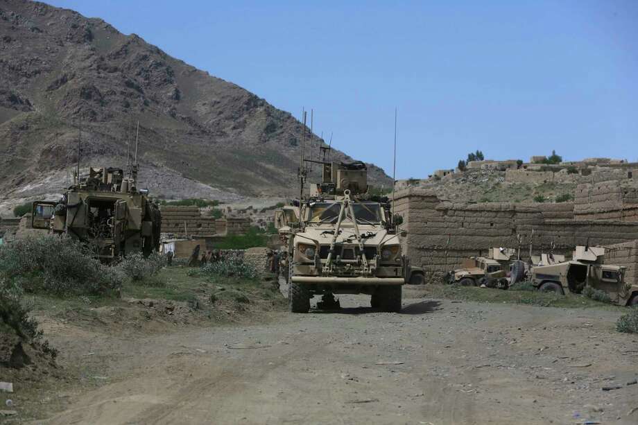 U.S. forces and Afghan commandos are seen in Asad Khil near the site of a U.S. bombing in the Achin district of Jalalabad, east of Kabul, Afghanistan, Saturday, April 17, 2017. U.S. forces in Afghanistan on Thursday struck an Islamic State tunnel complex in eastern Afghanistan with the largest non-nuclear weapon every used in combat by the U.S. military, Pentagon officials said. (AP Photo/Rahmat Gul) Photo: Rahmat Gul, STF / Copyright 2017 The Associated Press. All rights reserved.