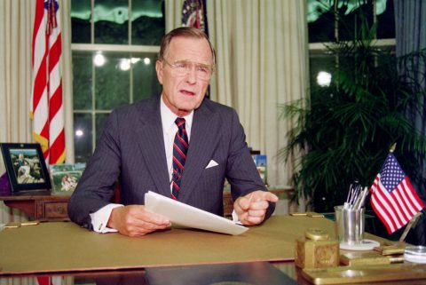 US President George Bush poses for photographers after his address to the nation, 27 September 1991, in the Oval Office of the White House. During his speech, Bush announced that the US will unilaterally eliminate its land and sea-based short-range nuclear weapons. (Photo credit should read LUKE FRAZZA/AFP/Getty Images)