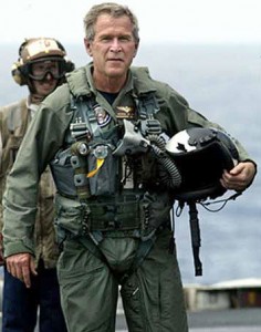 President George W. Bush in a flight suit after landing on the USS Abraham Lincoln to give his "Mission Accomplished" speech about the Iraq War. 