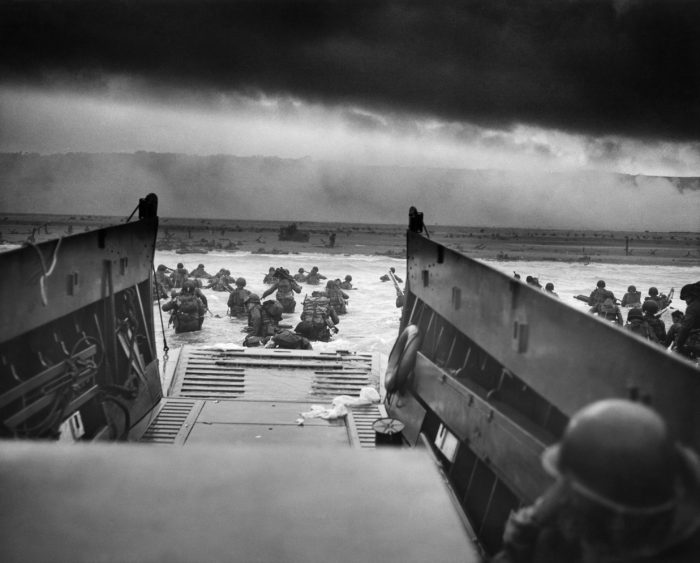 Troops of Company E, 16th Infantry, 1st Infantry Division (the Big Red One) wading onto the Fox Green section of Omaha Beach (Calvados, Basse-Normandie, France) on the morning of June 6, 1944. American soldiers encountered the newly formed German 352nd Division when landing. During the initial landing two-thirds of Company E became casualties. (Wikimedia) 