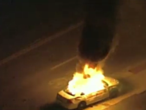 Car on fire outside of the Ferguson Police Department